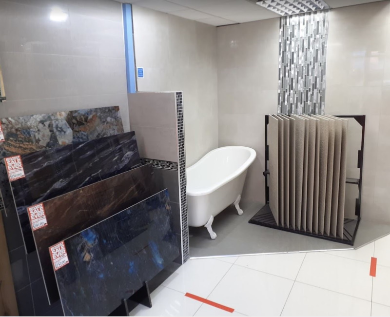 Different tile displays and a showroom type display with a bath fitted into an ivory tile display