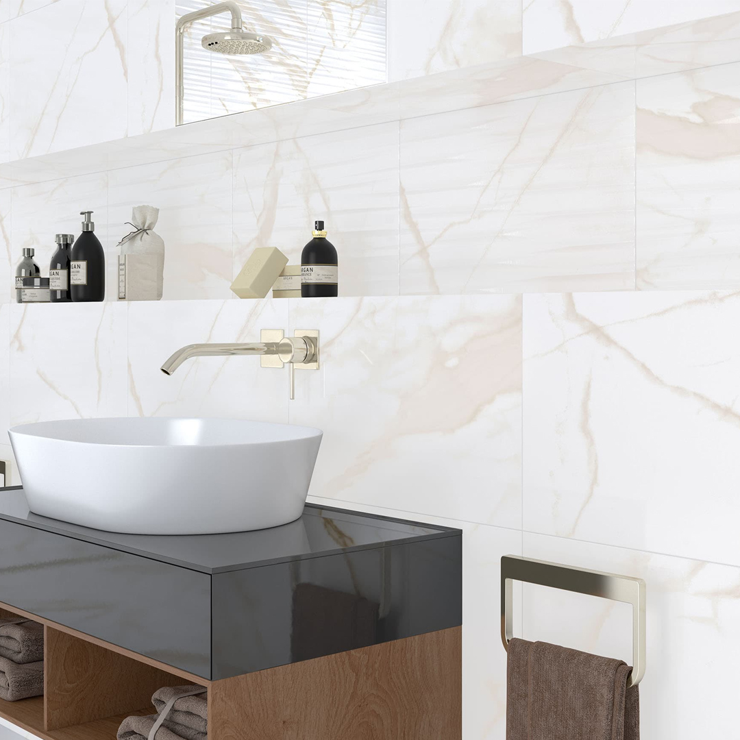 Bathroom sink area with marble effect wall tiles