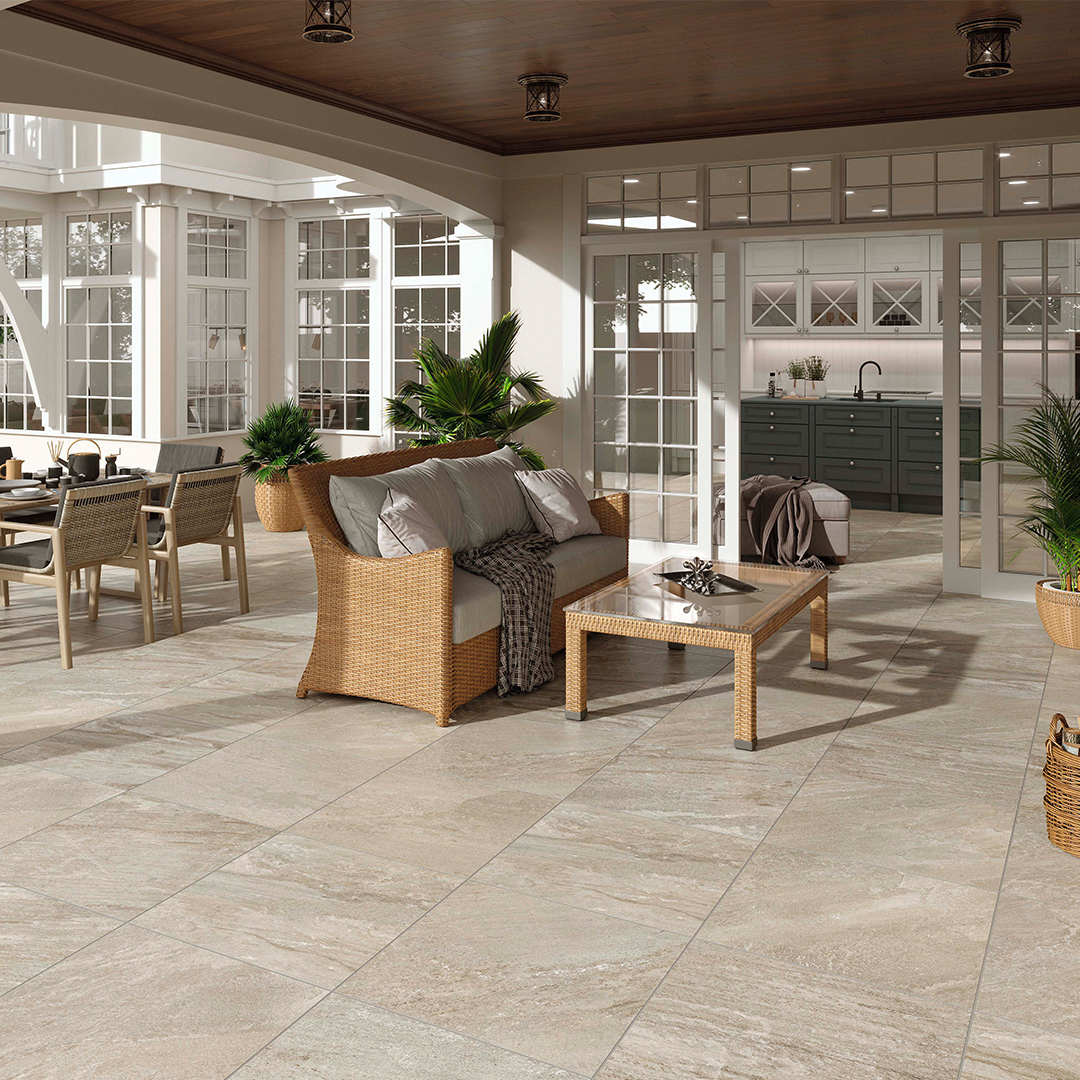Covered patio with beige floor tiles and a lounge set and table.