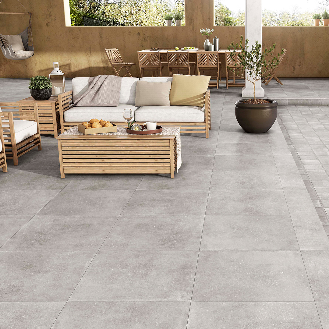 Patio with grey tiles and a lounge set.