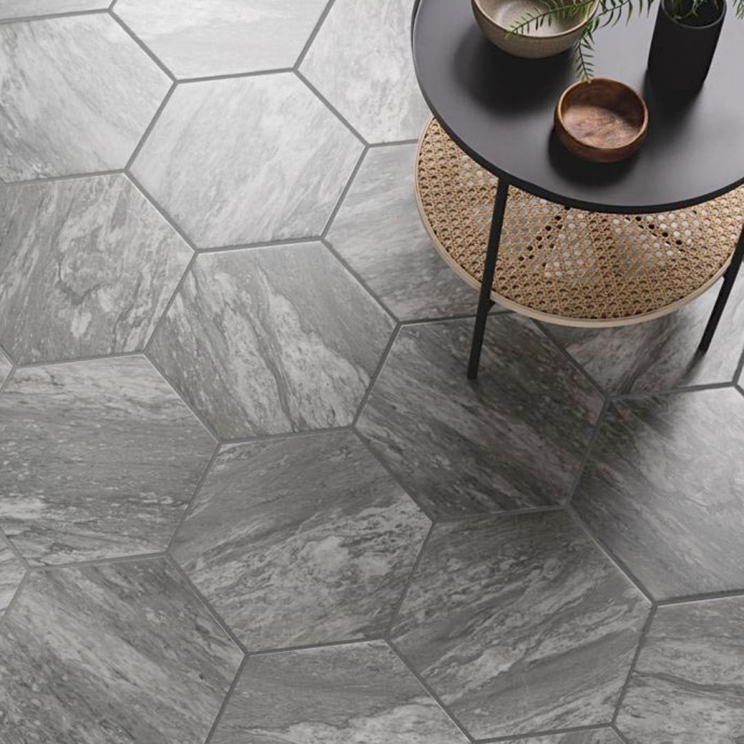 Hexagon floor tiles with light grey veining. There is a small side table to the right.