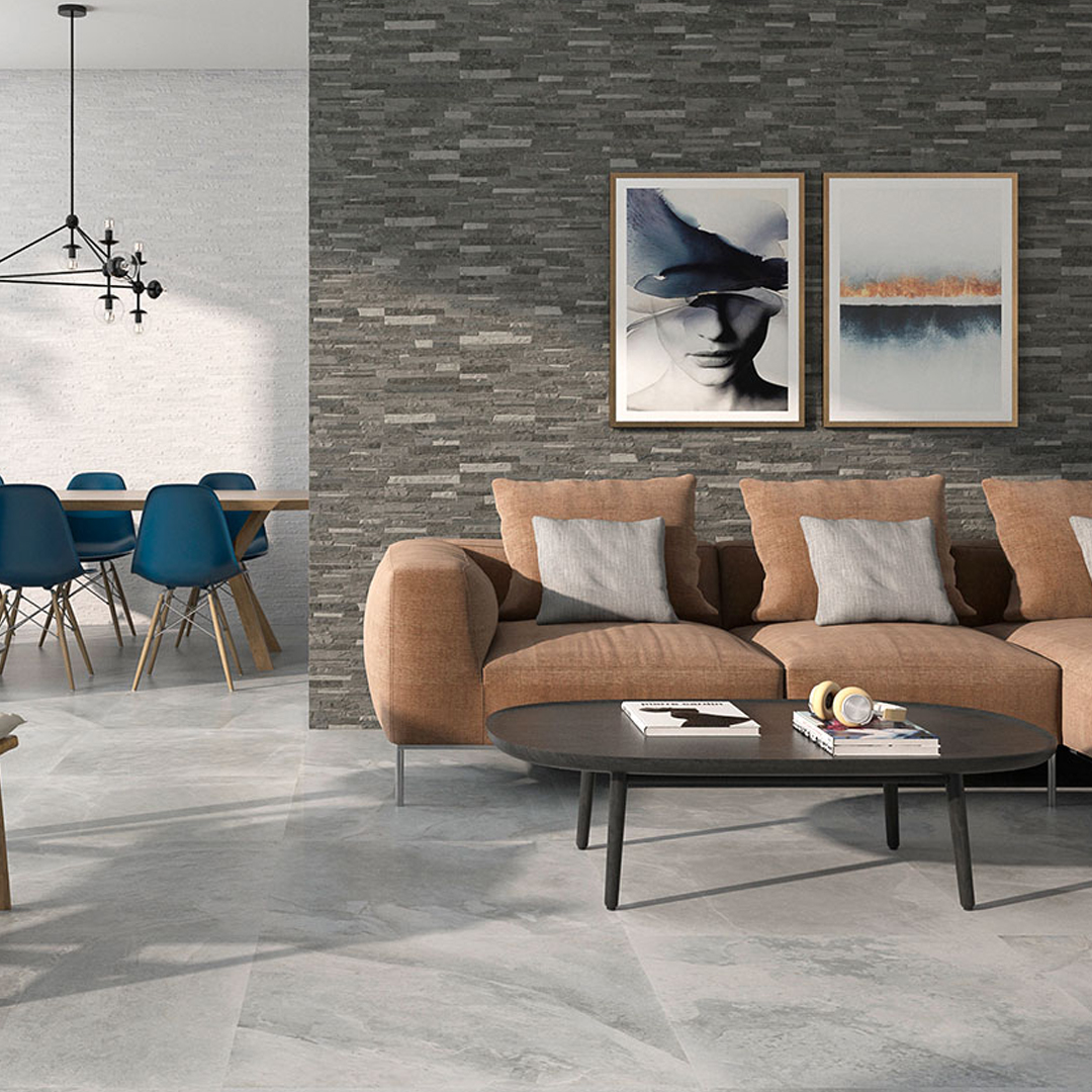 Rustic grey wall tiles in a living room with a beige sofa and black coffee table